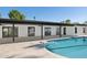 Sparkling pool and spacious tiled patio with sleek modern home exterior at 342 E Orangewood Ave, Phoenix, AZ 85020