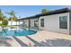 Inviting backyard pool with an extended patio and modern white exterior at 342 E Orangewood Ave, Phoenix, AZ 85020