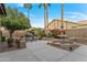 Landscaped backyard showcasing a fountain, palm trees, and vibrant bougainvillea at 3799 N 154Th Dr, Goodyear, AZ 85395