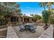 Stunning backyard patio featuring a cozy fire pit, water feature, and lush landscaping at 3799 N 154Th Dr, Goodyear, AZ 85395