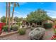 Expansive backyard view showcases the meticulously landscaped yard, water feature, and seating area at 3799 N 154Th Dr, Goodyear, AZ 85395