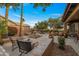 Well-designed backyard featuring a fountain, lush landscaping, and comfortable seating areas at 3799 N 154Th Dr, Goodyear, AZ 85395