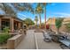 Expansive backyard featuring multiple seating areas, a fountain, and lush greenery at 3799 N 154Th Dr, Goodyear, AZ 85395