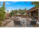 Beautiful backyard with a water fountain feature, mature trees, and inviting seating arrangements at 3799 N 154Th Dr, Goodyear, AZ 85395