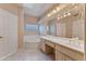 Well-lit bathroom with a double vanity, soaking tub, and decorative glass block window at 3799 N 154Th Dr, Goodyear, AZ 85395