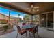 Inviting covered patio with a ceiling fan, overlooking a well-maintained backyard oasis at 3799 N 154Th Dr, Goodyear, AZ 85395