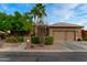 Single-story home with brown exterior, two-car garage, and landscaped yard at 3799 N 154Th Dr, Goodyear, AZ 85395