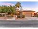 Inviting single-story home featuring a lush, landscaped front yard with desert plants and a two car garage at 3799 N 154Th Dr, Goodyear, AZ 85395