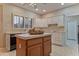 Kitchen island with white cabinets, tile countertop and a decorative fruit bowl at 3799 N 154Th Dr, Goodyear, AZ 85395