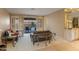 Bright living room with sliding doors to the outside, wet bar with illuminated shelving, and neutral colors at 3799 N 154Th Dr, Goodyear, AZ 85395