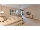 Bright main bedroom featuring a ceiling fan, window with shutters, and patio access at 3799 N 154Th Dr, Goodyear, AZ 85395