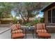 Inviting outdoor seating area with cushioned chairs, offering a peaceful retreat under a mature tree at 3799 N 154Th Dr, Goodyear, AZ 85395