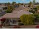 Home featuring a desert landscape with mature trees, a brick wall, and an outdoor air conditioning unit at 3799 N 154Th Dr, Goodyear, AZ 85395