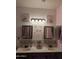 Double vanity bathroom with pink walls and decorative mirrors at 400 W Wisteria Pl, Chandler, AZ 85248