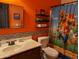 Bathroom with orange walls, and a mario themed shower curtain at 400 W Wisteria Pl, Chandler, AZ 85248