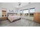 Main bedroom with large windows, light flooring, and plenty of natural light at 6659 N 127Th Dr, Glendale, AZ 85307