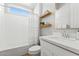 Clean bathroom with white vanity, bathtub, and floating shelves at 7250 W Pinnacle Vista Dr, Peoria, AZ 85383