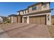 Two-story house with a three-car garage and brick paver driveway at 7250 W Pinnacle Vista Dr, Peoria, AZ 85383