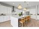 Modern kitchen with white cabinets, quartz countertops, and a large island at 7250 W Pinnacle Vista Dr, Peoria, AZ 85383