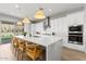 Modern kitchen with white cabinets, quartz countertops, and stainless steel appliances at 7250 W Pinnacle Vista Dr, Peoria, AZ 85383