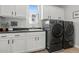 Laundry room with washer, dryer, and white cabinets at 7250 W Pinnacle Vista Dr, Peoria, AZ 85383