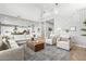 Open living space with high ceilings, showcasing a comfortable sectional sofa and a view into the kitchen at 7250 W Pinnacle Vista Dr, Peoria, AZ 85383