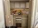 Home wet bar with liquor, glassware, and ice maker at 7343 E Marlette Ave, Scottsdale, AZ 85250