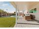 Covered patio with seating area overlooking the pool and grassy backyard at 8437 E San Miguel Ave, Scottsdale, AZ 85250