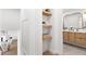 Modern bathroom with light wood shelving and view to another bathroom at 8437 E San Miguel Ave, Scottsdale, AZ 85250