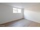 Bright bedroom featuring hardwood floors and large window at 8437 E San Miguel Ave, Scottsdale, AZ 85250