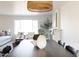 Dining area with a dark wood table and wicker pendant lighting at 8437 E San Miguel Ave, Scottsdale, AZ 85250