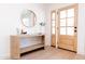 Light and bright entryway with console table and round mirror at 8437 E San Miguel Ave, Scottsdale, AZ 85250