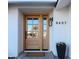 Light brown front door with glass panels and welcome mat at 8437 E San Miguel Ave, Scottsdale, AZ 85250