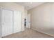 This bedroom features neutral walls and carpet and a closet with sliding doors at 8808 W State Ave, Glendale, AZ 85305