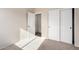 This bedroom features neutral walls and carpet and a closet with sliding doors at 8808 W State Ave, Glendale, AZ 85305