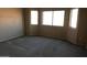 Bright bedroom with carpeted floor and large windows at 8808 W State Ave, Glendale, AZ 85305