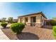 Front exterior view showing well-kept desert landscaping, a covered porch, and stone accents at 8808 W State Ave, Glendale, AZ 85305