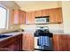 Bright kitchen featuring stainless steel appliances, wooden cabinets, and light countertops at 8808 W State Ave, Glendale, AZ 85305