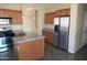 Kitchen with stainless steel refrigerator and ample wood cabinetry at 8808 W State Ave, Glendale, AZ 85305