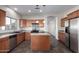 Well-equipped kitchen featuring a gas range, stainless appliances, and a center island for added prep space at 8808 W State Ave, Glendale, AZ 85305