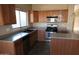 Spacious kitchen with wood cabinets, stainless steel appliances, and an island at 8808 W State Ave, Glendale, AZ 85305