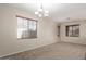 Bright living room with neutral walls and carpet flooring and windows with wood blinds at 8808 W State Ave, Glendale, AZ 85305