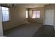 Spacious living room with neutral colored walls and carpet flooring at 8808 W State Ave, Glendale, AZ 85305