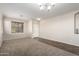 Open living space with tile and carpet flooring, neutral colors, and lots of natural light at 8808 W State Ave, Glendale, AZ 85305