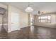 Spacious living area with tile flooring, neutral walls, a ceiling fan, and a sliding glass door at 8808 W State Ave, Glendale, AZ 85305