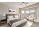 A serene main bedroom features a plush bed, neutral tones, and bright natural light from the multiple windows at 8808 W State Ave, Glendale, AZ 85305