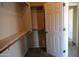 Spacious walk-in closet with wood shelving and hanging rods at 8808 W State Ave, Glendale, AZ 85305