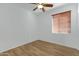 Bright bedroom with wood-look flooring and ceiling fan at 931 S Porter Ct, Gilbert, AZ 85296