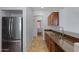 Kitchen with stainless steel refrigerator and granite countertops at 931 S Porter Ct, Gilbert, AZ 85296