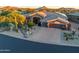 Single-story home with desert landscaping and driveway at 9771 E Roadrunner Dr, Scottsdale, AZ 85262